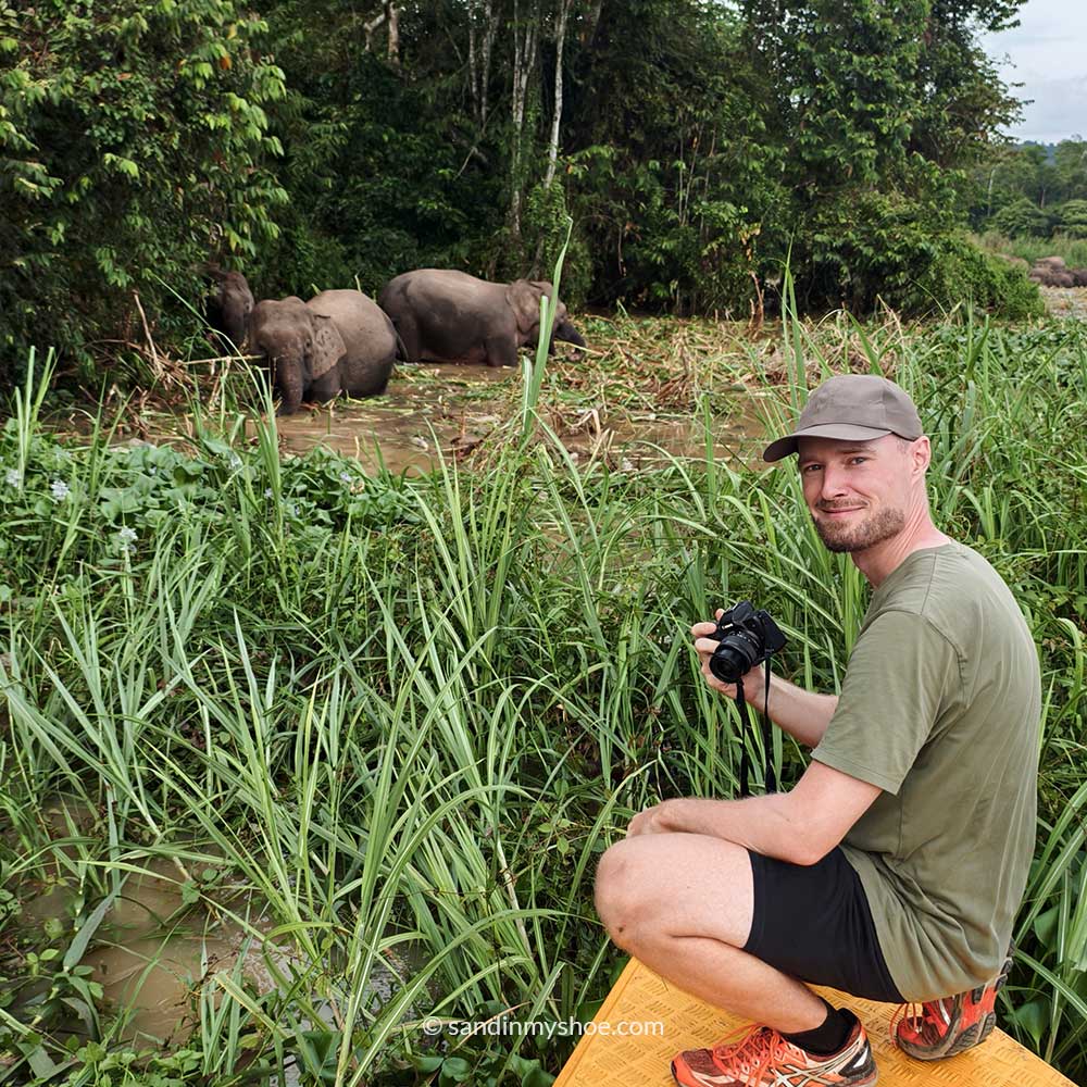 Petteri posing with Pygmy Elephants during river cruise in Kinabatangan — a must in any borneo itinerary.