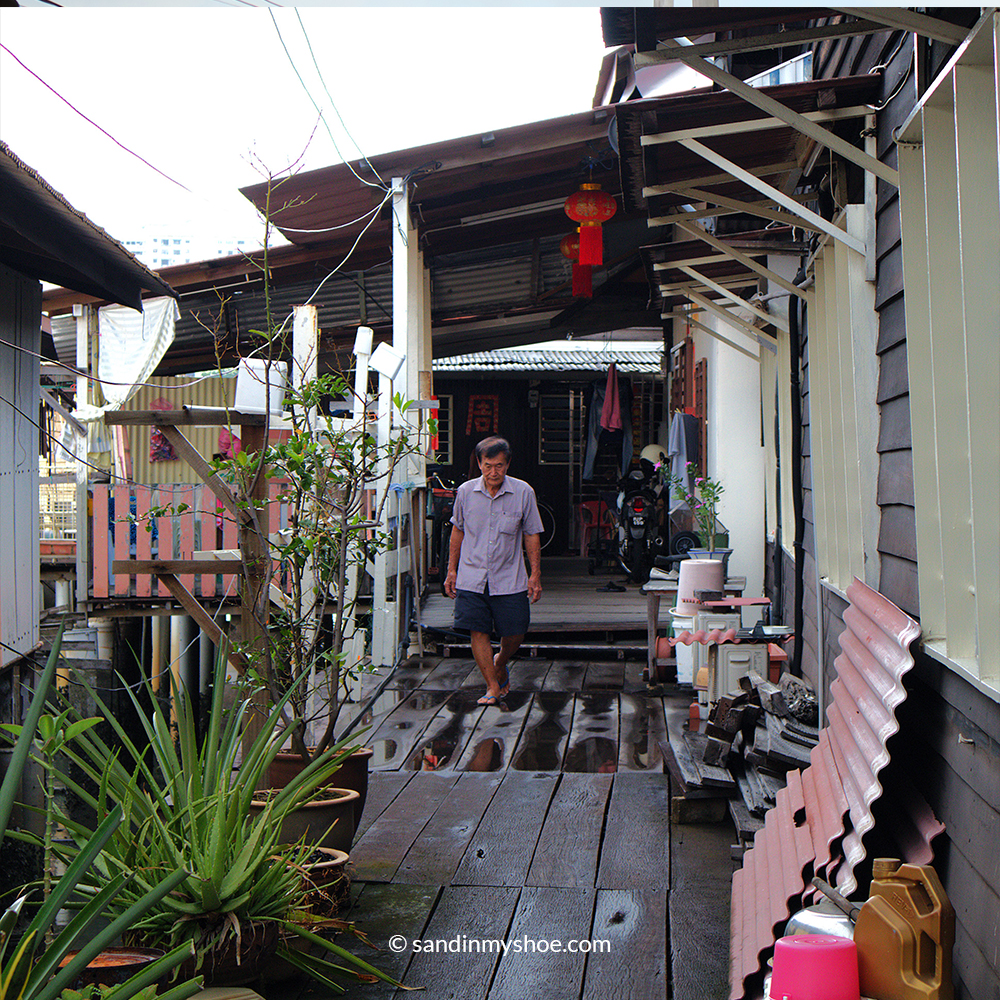 Local man walking in Chew Jetty area in George Town, Penang