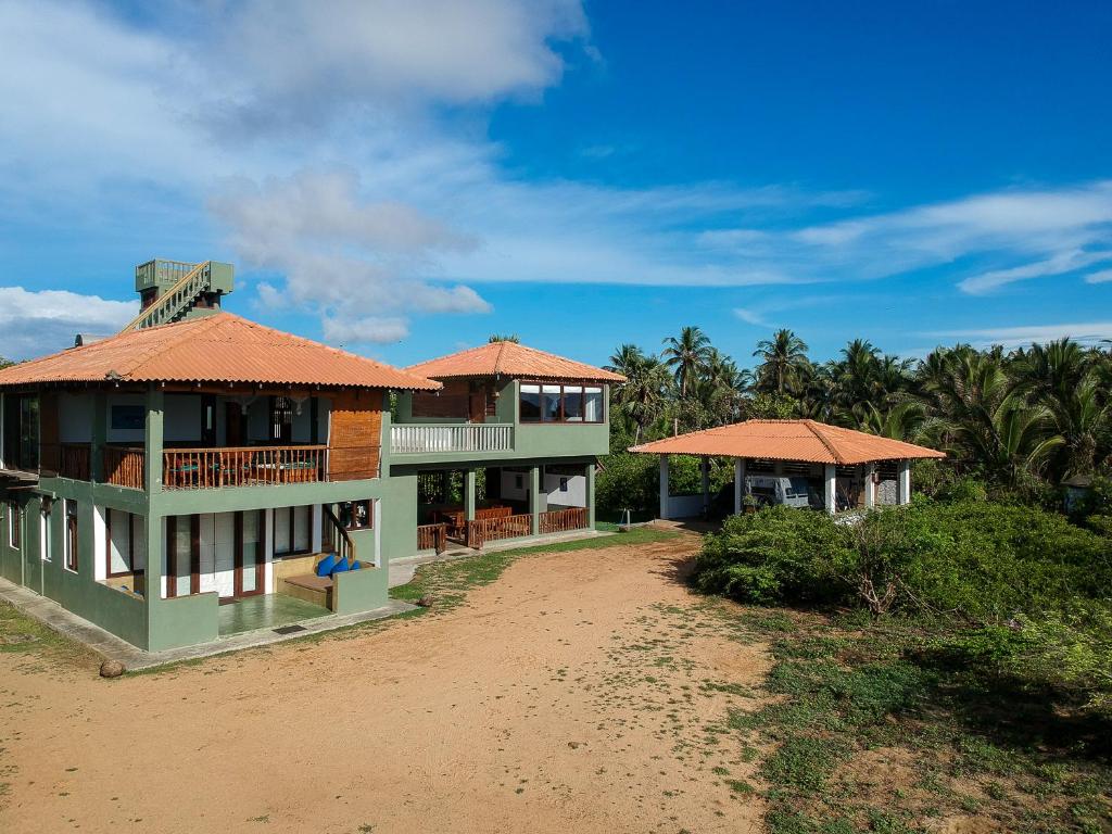 Exterior view of Kudakalliya Beach House with rooms spread across small building.