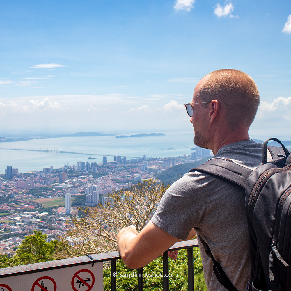 Petteri standing at a Penang Hill viewpoint with a wide view of George Town and the coastline below.