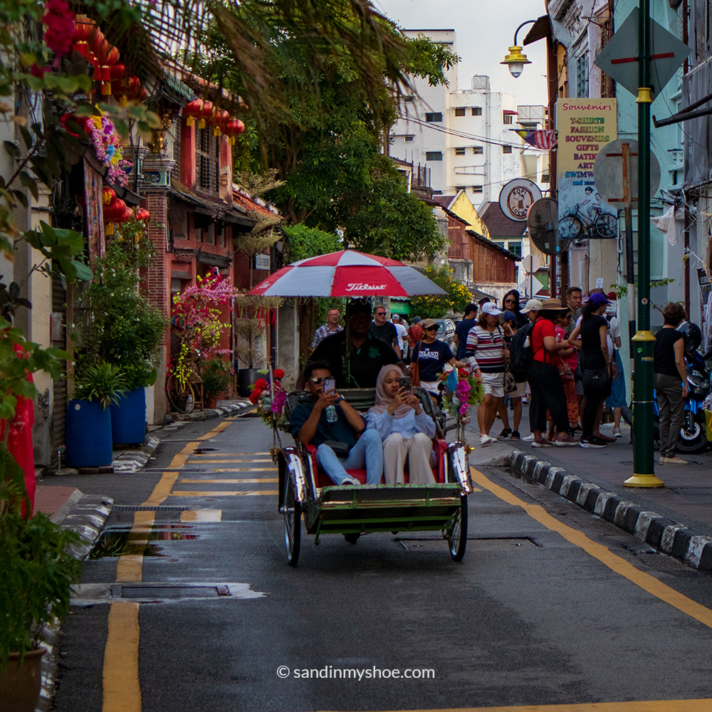 Ricksaw with passengers in George Town, Penang