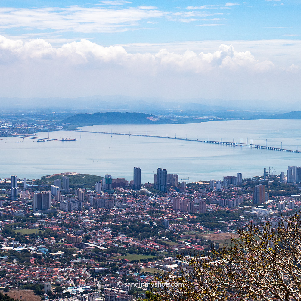 Panoramic view of Penang from Penang Hill, showing the city, coastline, and surrounding greenery.