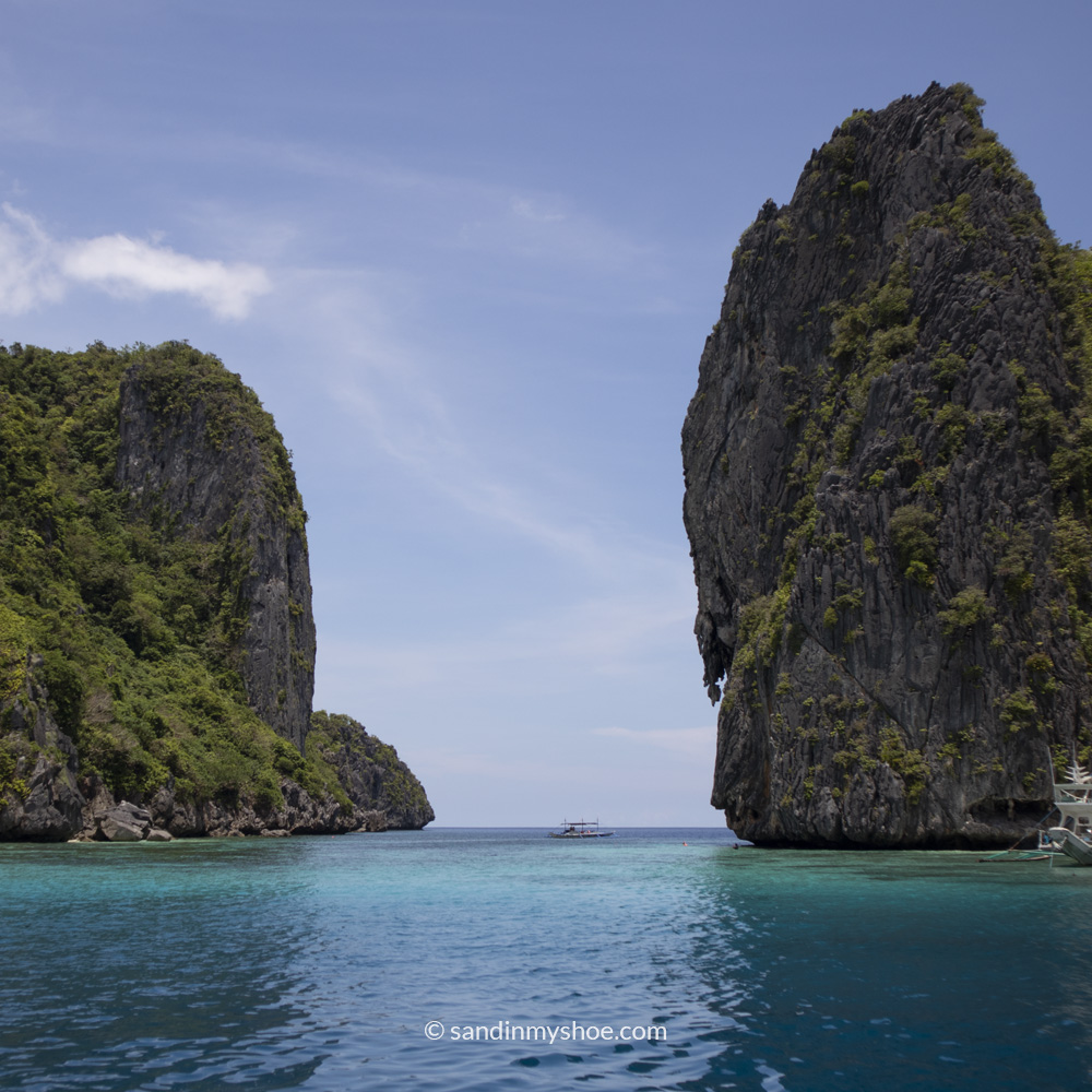 Turquoise water flowing between two steep, lush hilltops — a scenic view that captures why this area belongs on any list of where to go in the Philippines.