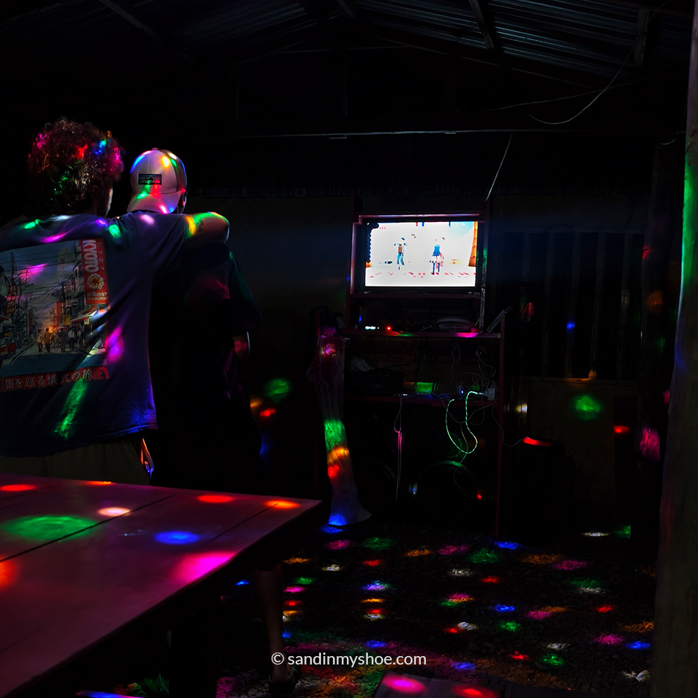 People singing karaoke at night.