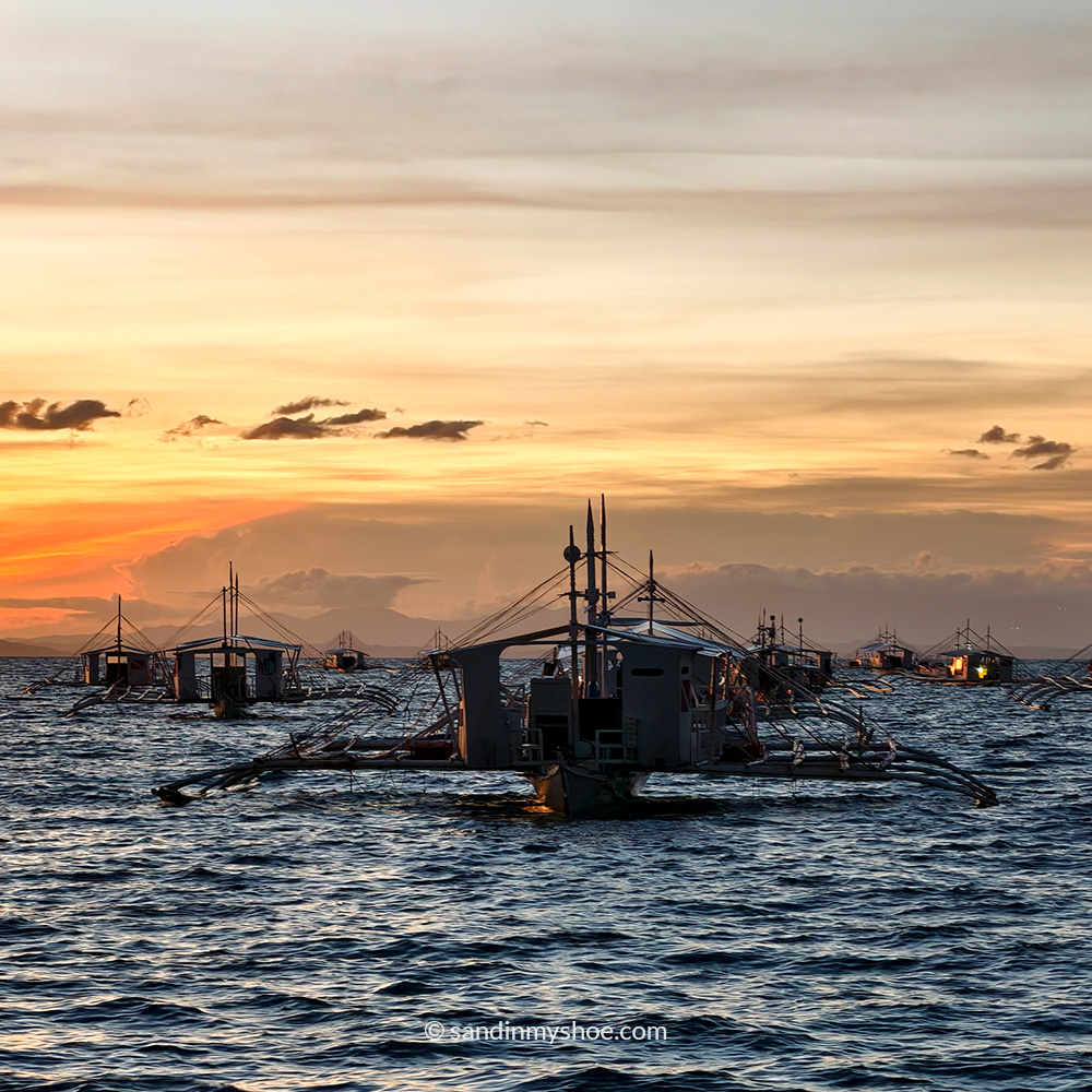many dive boats heading to Monad Shoal one early morning in Malapascua, Philippines.