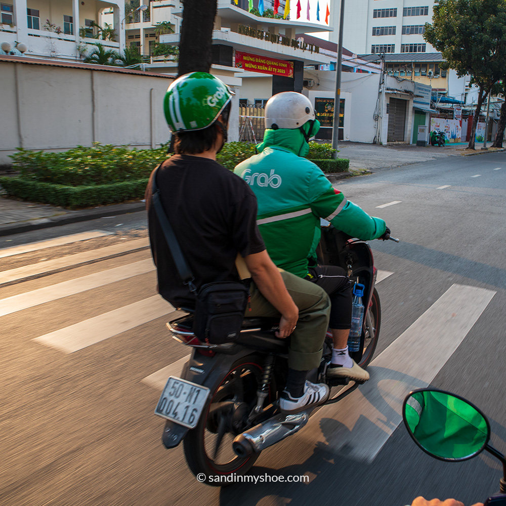 Local getting a ride by a grab motorbike driver.
