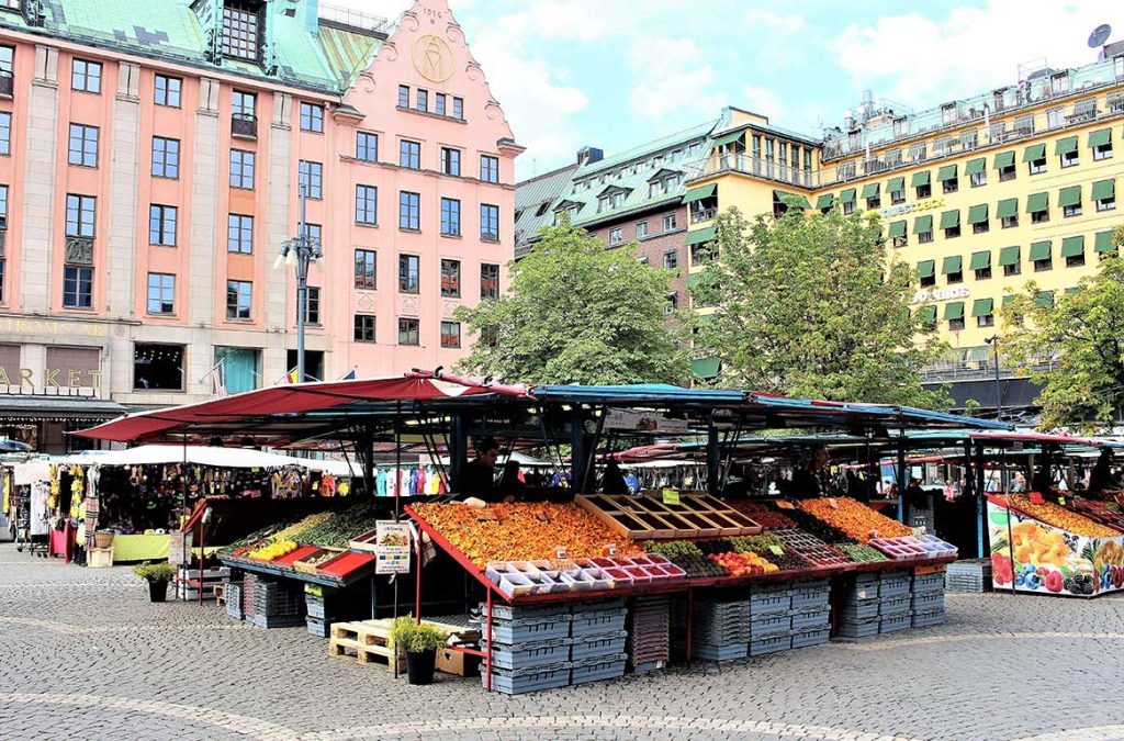 Hötorget in Stockholm on a summer day, filled with fruit stalls and small vendors.