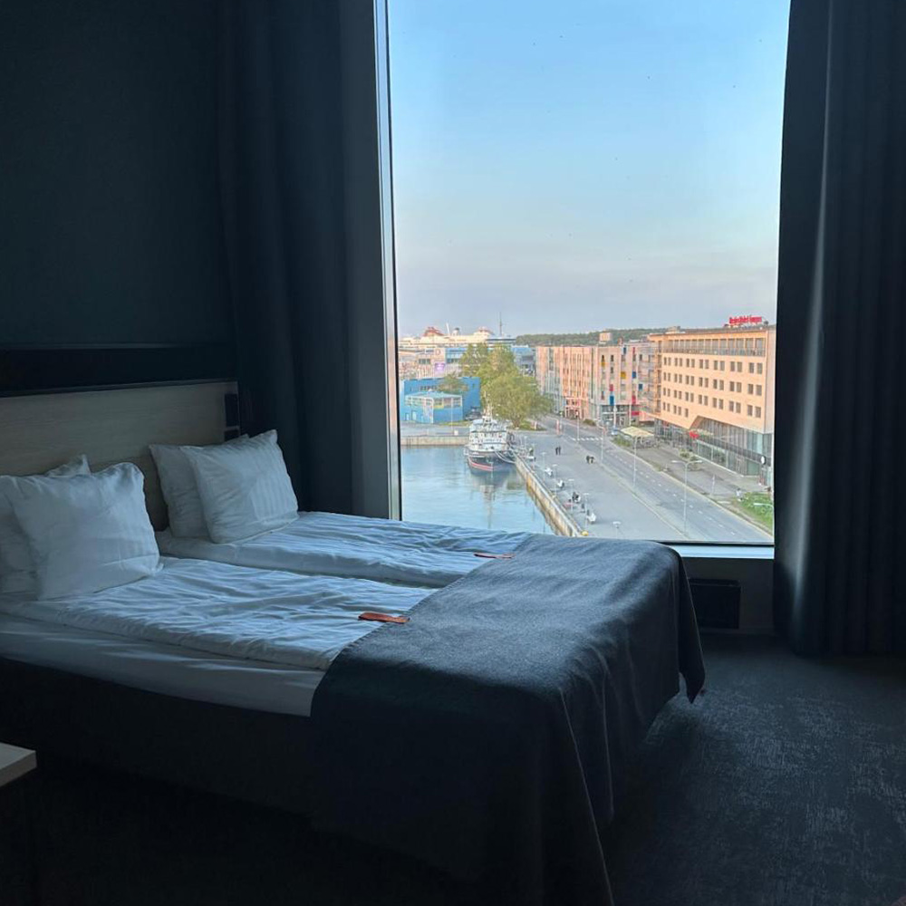 Hotel room in Sadama with a view of the port through the window.