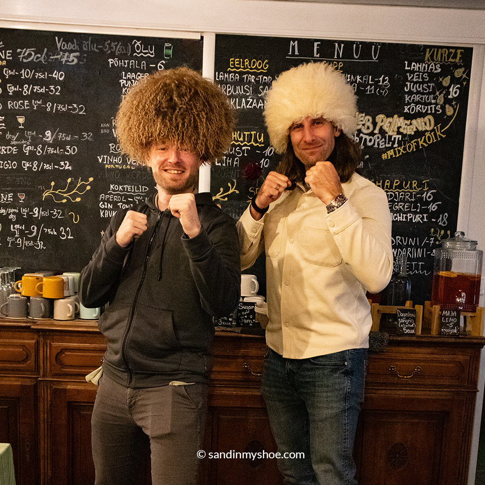 Petteri and his friend trying Dagestani hats after the meal. 