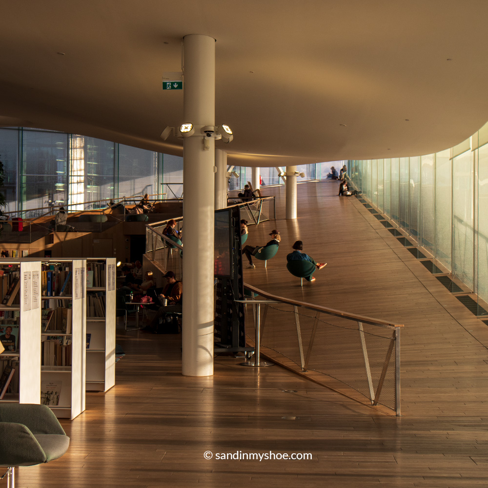 The inside of Oodi Library where the flooring follows the wavy architecture.