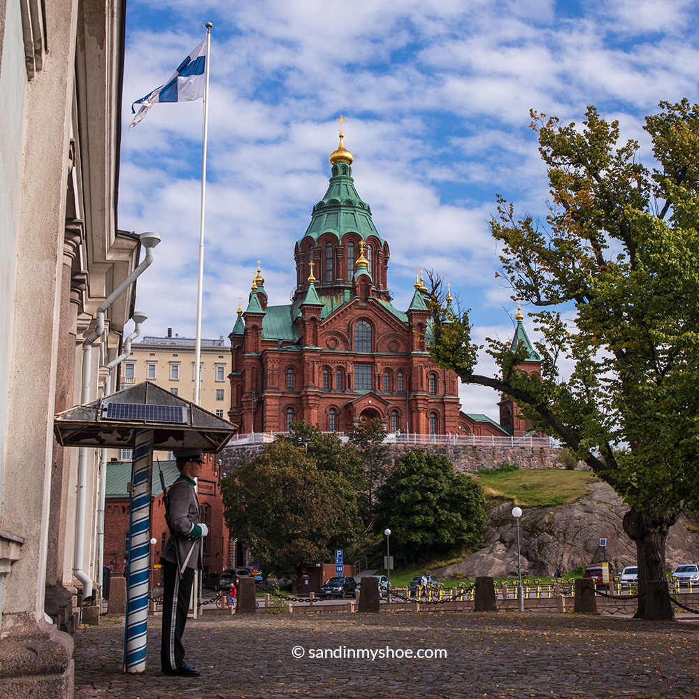 Uspenski cathedral with its red-brick exterior, pale green roof and golden domes.
