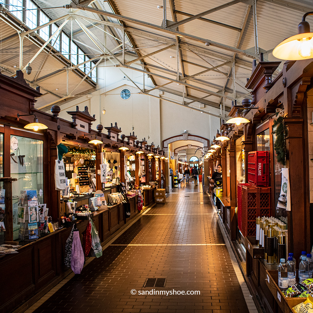 Multiple vendors at old market hall in Helsinki.